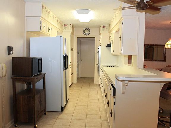 Kitchen has tons of cabinets and drawers for all your storage needs. Just beyond the Kitchen you'll find a 1/2 bath & utility room + door to garage.