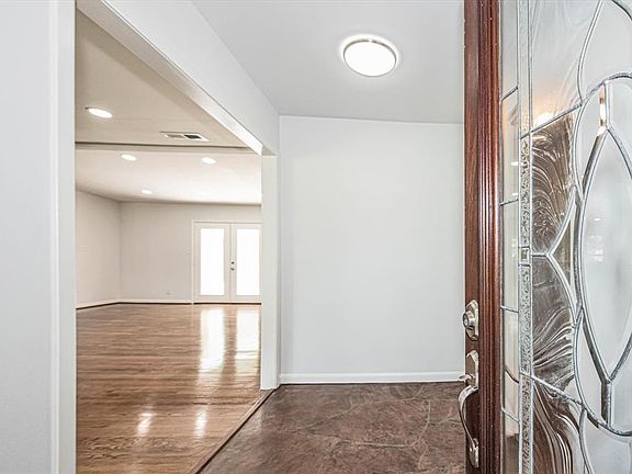 Leaded glass front door and stone flooring in foyer.