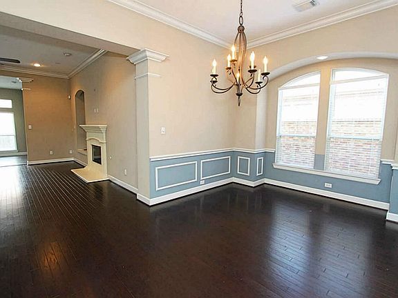 The dining room has a large window and a hardwood floor.