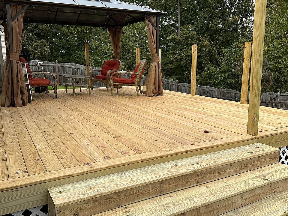 Fenced in back yard and deck with pergola