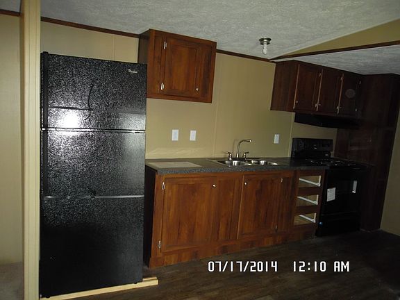 Kitchen Equipped With Fridge and Stove