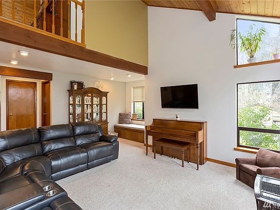 Living Room with Upstairs Landing above.  Windows everywhere.