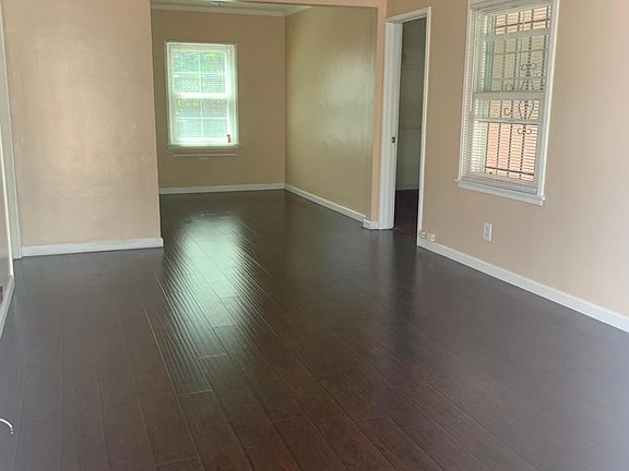 Living & Dining Room ample natural light and laminate flooring.