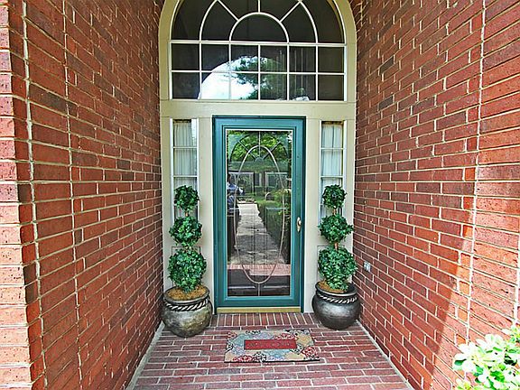 Red-brick porch leads you to a finely-crafted solid oak door!