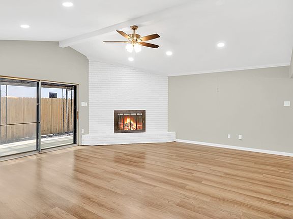 Huge living area is wide open and has a high vaulted ceiling.