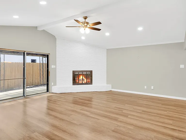 Huge living area is wide open and has a high vaulted ceiling.