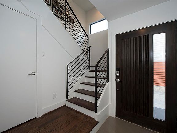 Stairs and coat closet are offset from the entrance hall