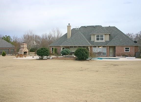 Vacation at home in this fabulous yard with inground gunite pool, outdoor fireplace, playground (not pictured here), and lots of space for impromptu sports!