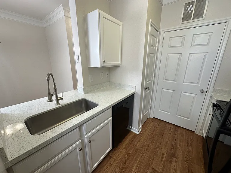 Chic and modern kitchen featuring elegant cabinetry, quartz countertops, and a stylish faucet, perfect for contemporary living. Chic and modern kitchen featuring elegant cabinetry, quartz countertops, and a stylish faucet, perfect for contemporary living.