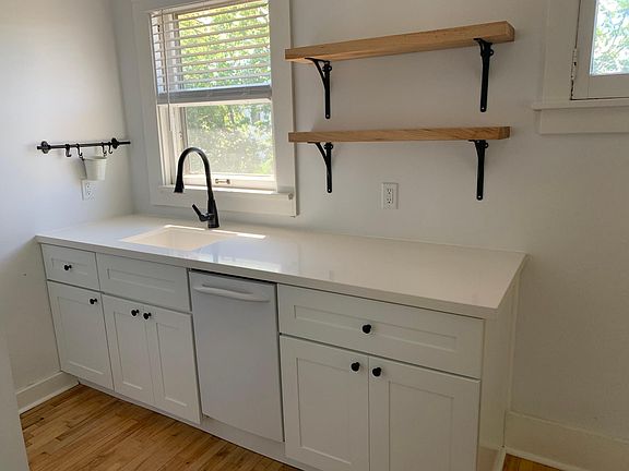 Quartz counter tops, soft close cabinets/drawers, dishwasher and composite sink with sprayer