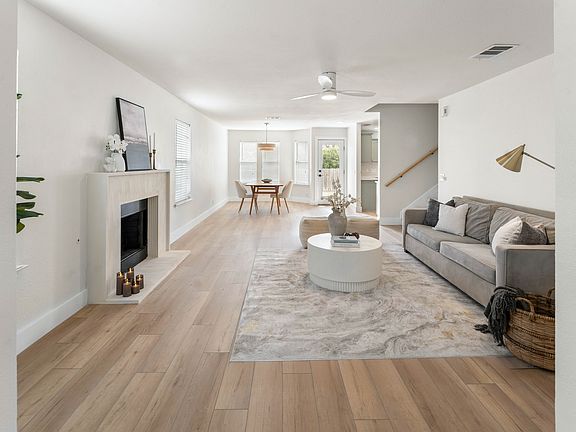 Open living and dining area designed for both everyday comfort and easy hosting, featuring a gas fireplace.