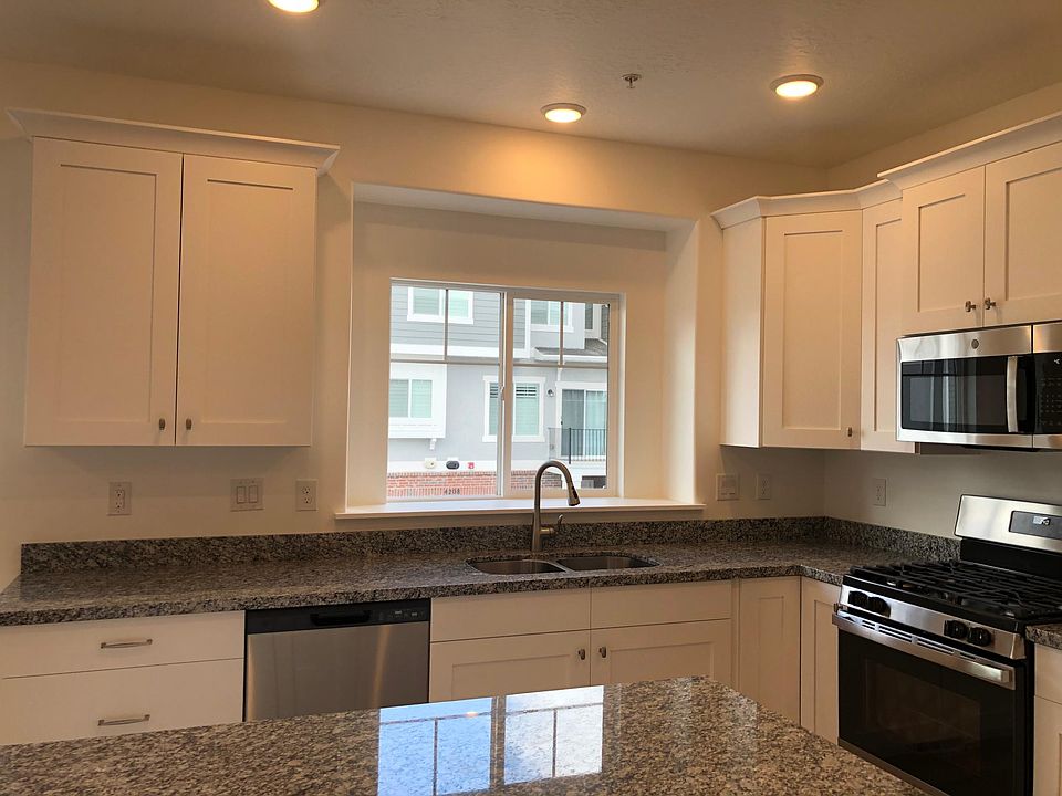 Main level - kitchen with upgraded faucet. Island with drawers and cabinets. Upgraded cabinet doors, drawers and hardware.