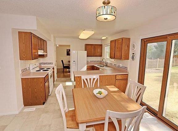Spacious kitchen and breakfast room with sliding glass doors to backyard