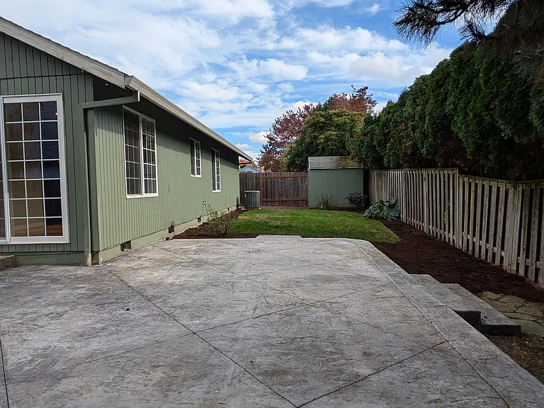 Fenced private backyard with patio, lawn and shed