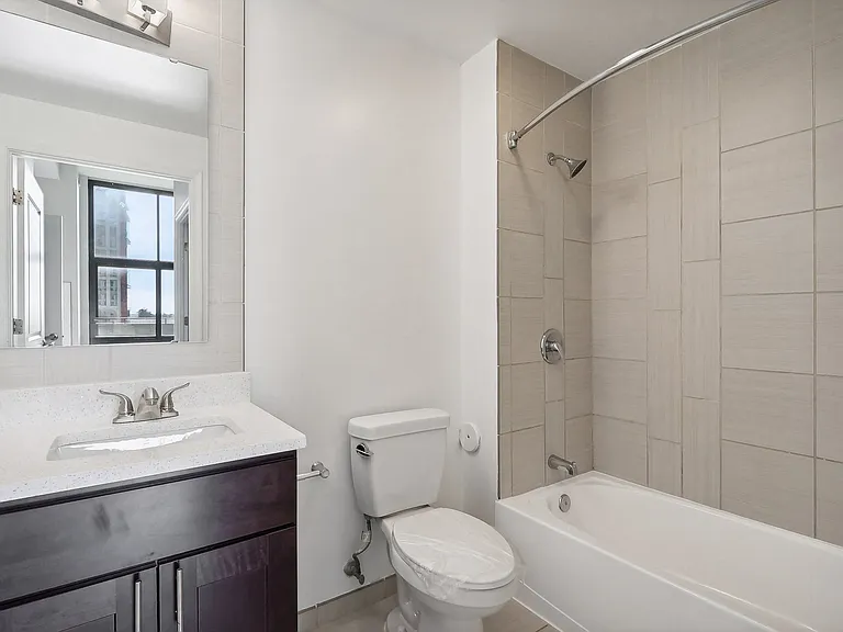a bathroom with a toilet sink and tub and a shower