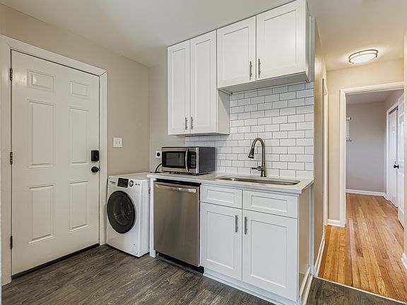 Big open sink, dishwasher, washer dryer combo. Exterior back door.
