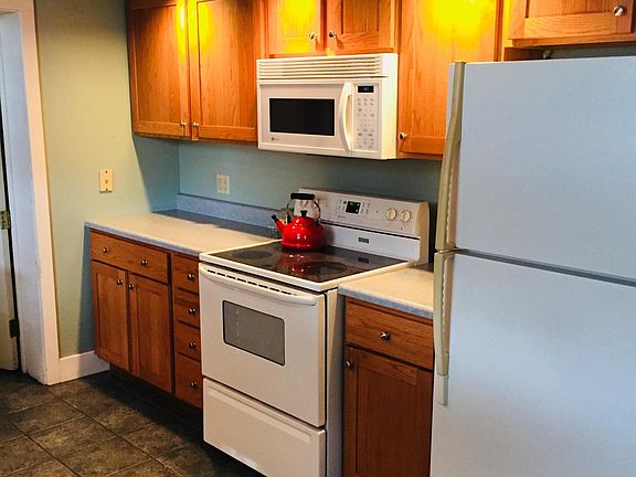electric stove/oven, microwave and ceramic tile floor