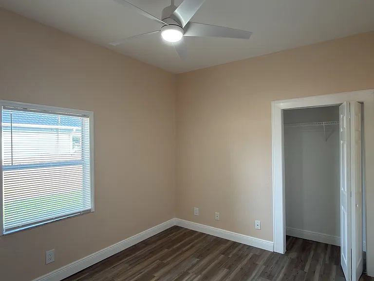 Primary Bedroom facing window and closet on right side