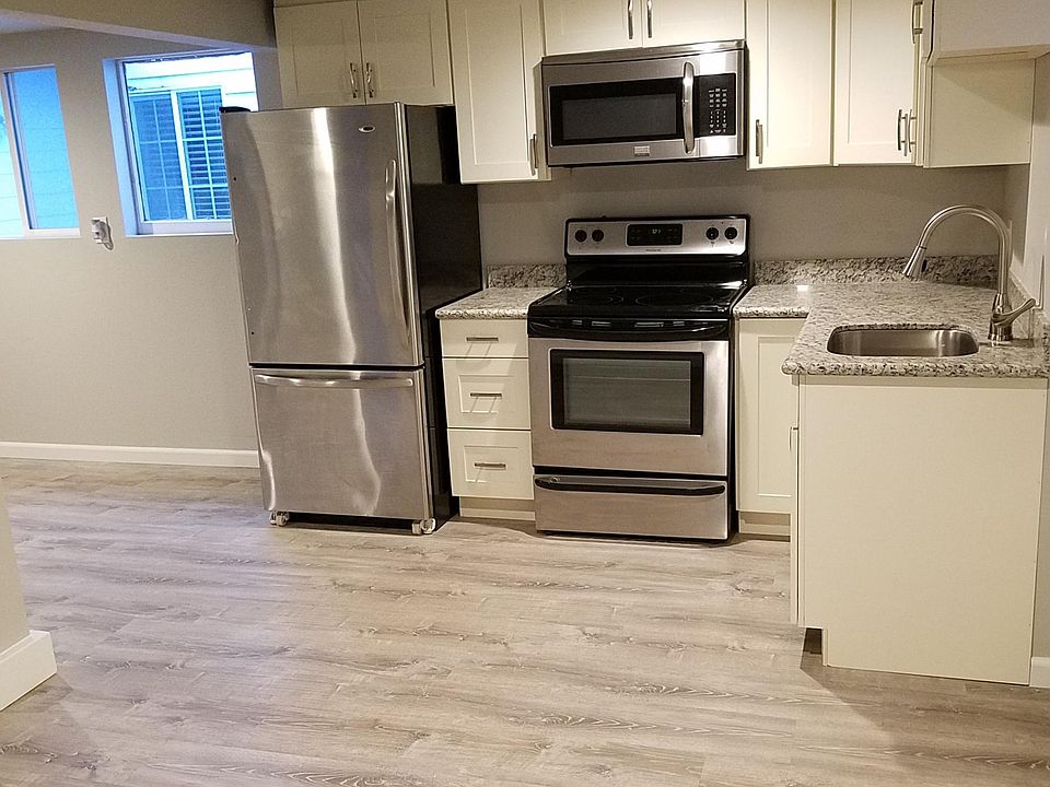 Kitchen with granite counters and new stainless steel applia
