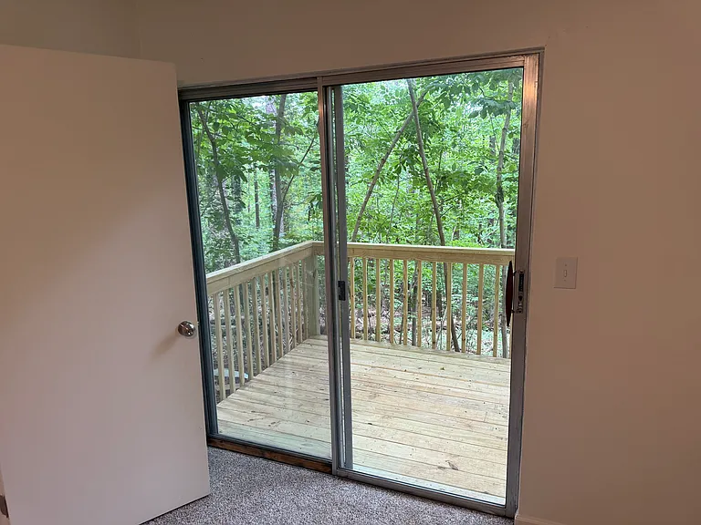 view from bedroom; sliding glass doors to deck