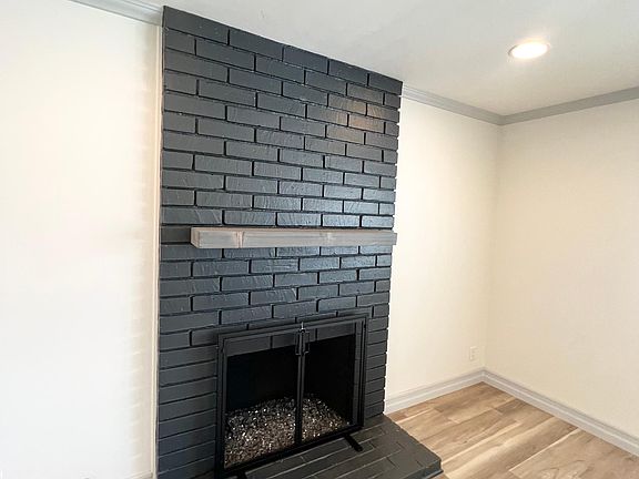 Wood mantle, glass rocks for elegant, cozy fires in the fireplace