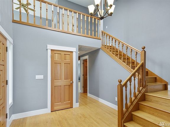 Soaring ceilings, beautiful wood doors, craftsman millwork and gleaming hardwood floors make a grand entrance in this home. 