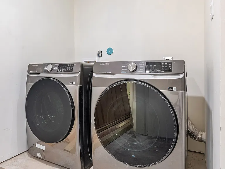 Convenient utility space in garage with washer/dryer connections.