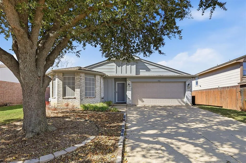 Ranch-style house featuring brick siding, an attached garage, and driveway - 7733 Liz Ln