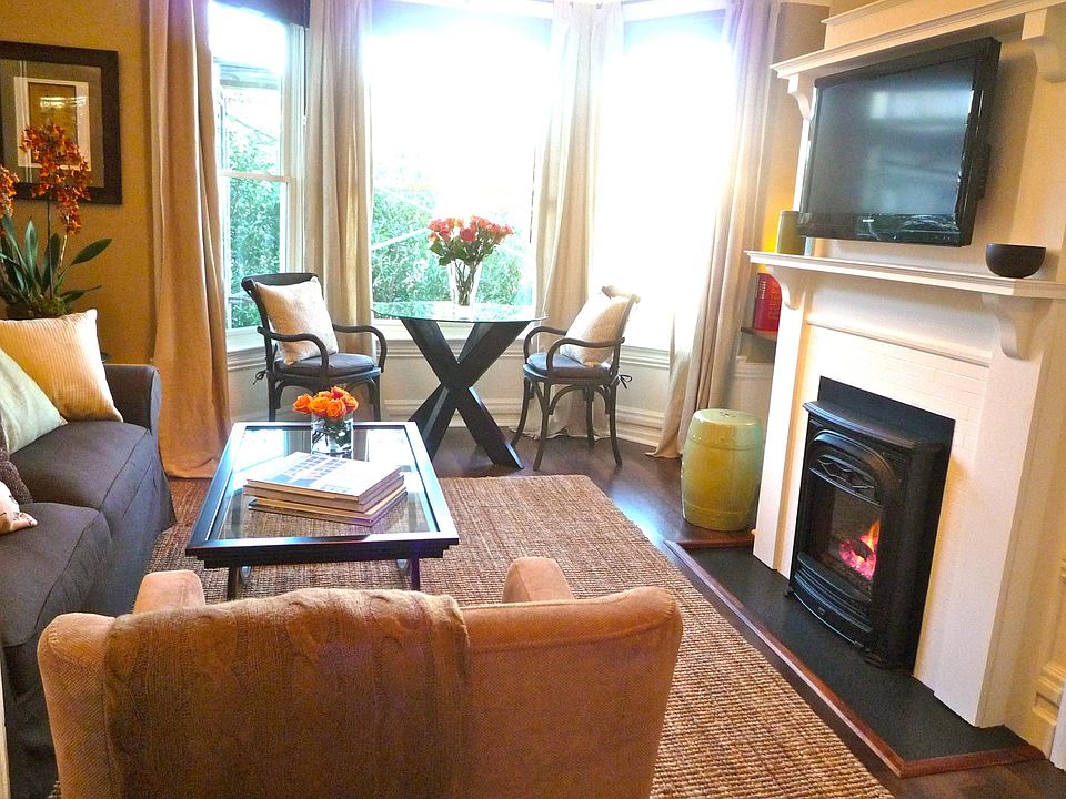 Living room with bay window, gas fireplace. Apartment is unfurnished.