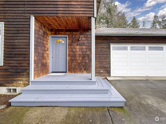 Cover porch at entry.  Cedar shingles is a nice touch.>