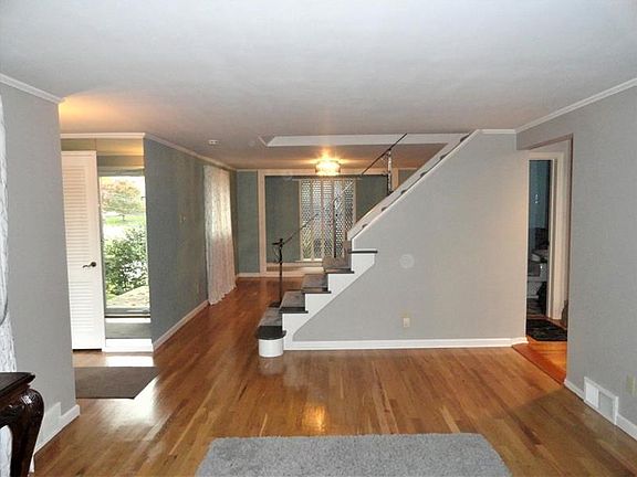 In this photo take from inside the formal living room you see the mirrored main entry on the left.  Beyond the stair is the form