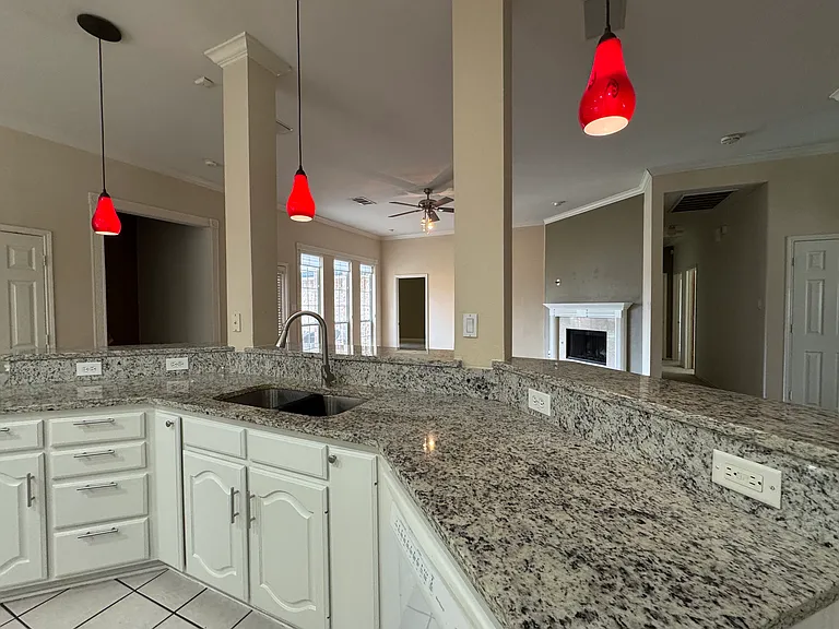 Kitchen with Granite Countertop and White Cabinets
