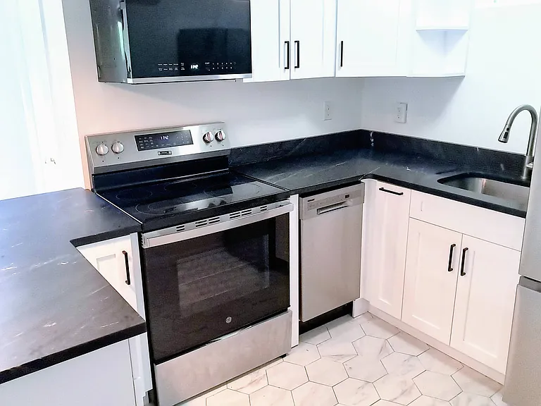 Entirely new kitchen with new appliances: microwave, dishwasher, oven and refrigerator.