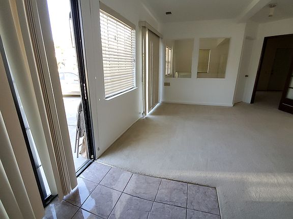 Main Entry sliding glass door & front unit window, eqquipped with vertical blinds for privacy.