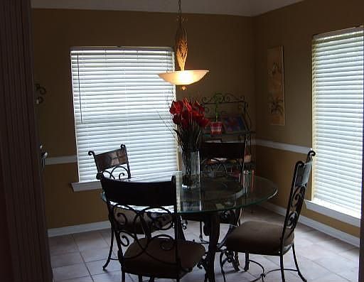 Sunny dining area off the kitchen leads to a pine -free back yard 