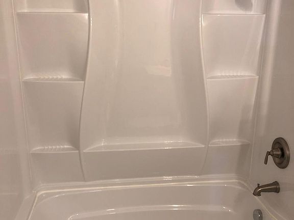 new bathtub with shelving