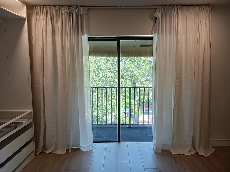 Master bedroom wardrobe and balcony facing east toward river