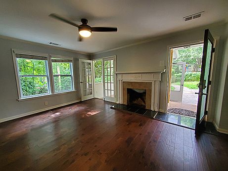 Living room with decorative fireplace and French doors to screened patio.