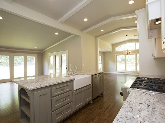 Perfect for entertaining, this dream Kitchen is designed for a full-size side-by-side refrigerator and freezer and is enhanced by the gorgeous glass tile backsplash framing a 6-burner stainless steel gas range.