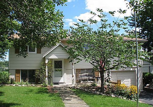 Lovely trees, bushes & perennials welcome you to this home.