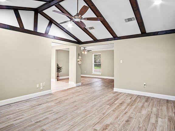 Family room with cathedral ceiling and remote controlled fan/light.