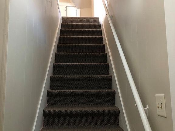 The stairs into the unit (newly carpeted, freshly painted walls, motion light included).