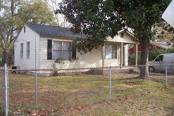 Front of house. Front yard is fenced.