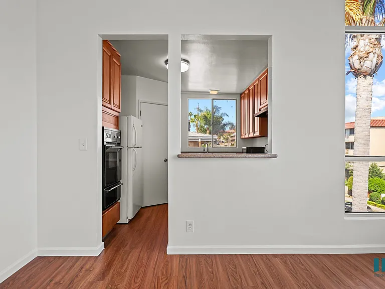 Dining Area with Large-Size Windows and Kitchen