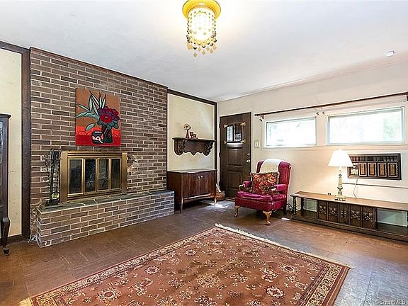Family room with wood burning fireplace and door to the backyard and patio.