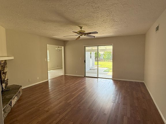 Family Room view from entry hall. Entry to kitchen on lift and Sliding Door to backyard patio in center.
