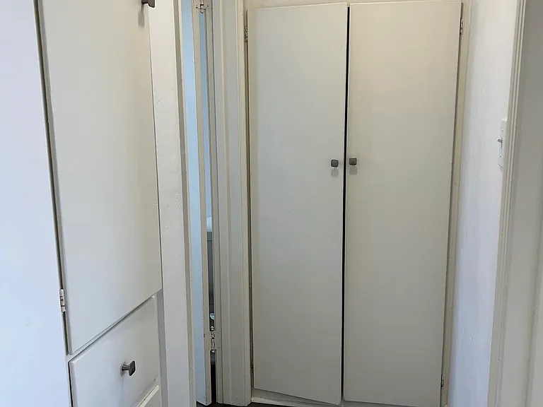 Hall Area with Built-In Closets, Drawers & Cupboards - Leads to Bedroom and Bathroom Doors