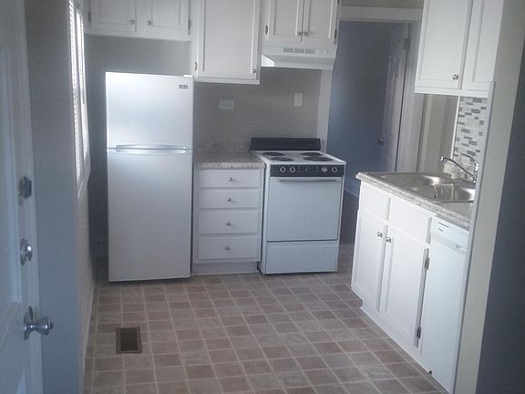 Everything you need in a bright, tidy kitchen! All new flooring, counters, backsplash, and cabinets. All appliances are provided - stove, refrigerator, and dishwasher. A breakfast room is adjacent to the kitchen for comfortable dining.
