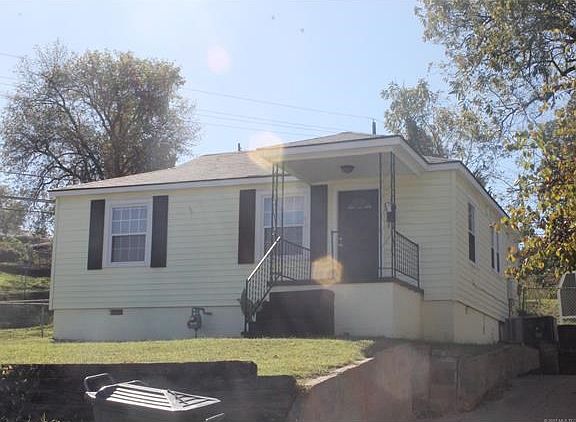 Plenty of parking in the driveway with well built concrete steps going up to yard and house