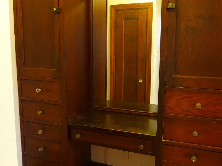 Floor-to-ceiling cabinetry in dressing room.